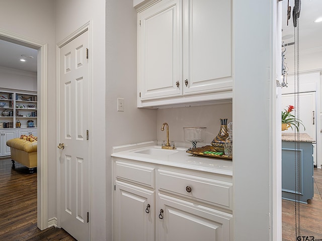 bar with sink, white cabinetry, and dark hardwood / wood-style floors