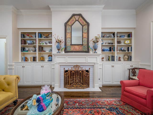 living room featuring a brick fireplace, crown molding, and dark wood-type flooring