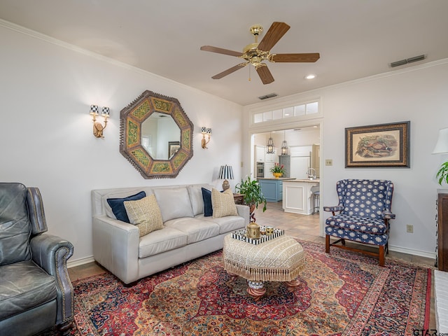 tiled living room featuring ceiling fan and crown molding