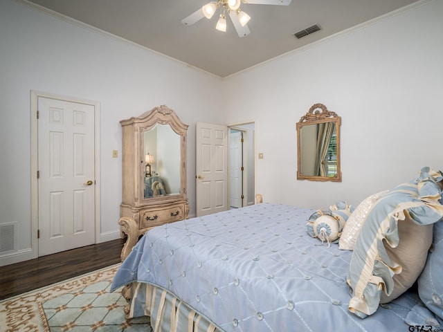 bedroom featuring ceiling fan, crown molding, and dark hardwood / wood-style floors