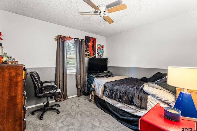 bedroom with a textured ceiling, light colored carpet, and ceiling fan