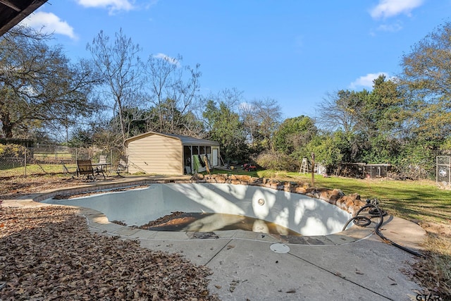 view of swimming pool with an outbuilding