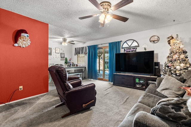 carpeted living room featuring ceiling fan and a textured ceiling