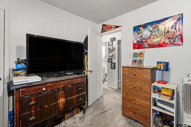 bedroom featuring a textured ceiling and light carpet