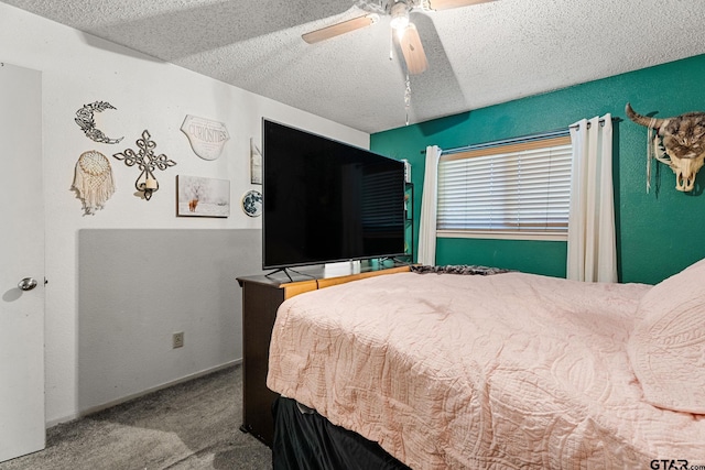 bedroom featuring carpet, ceiling fan, and a textured ceiling