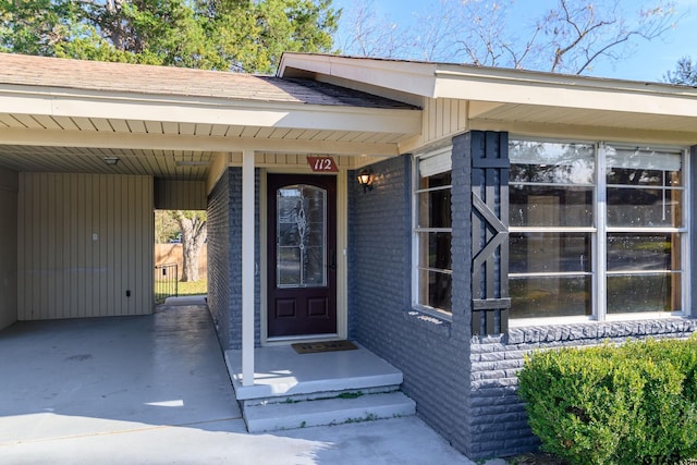 view of exterior entry with a carport