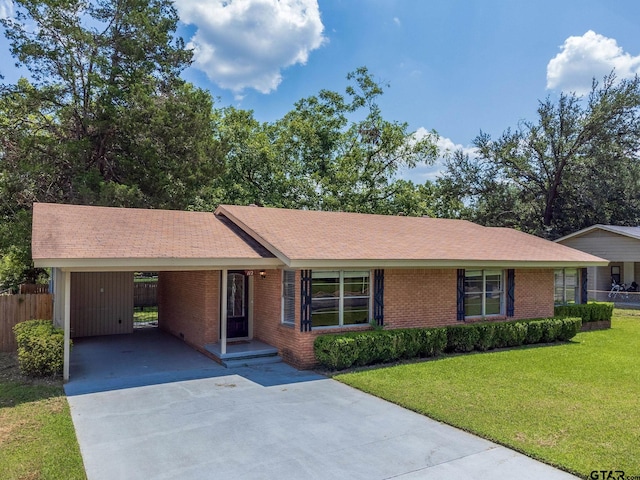 ranch-style home with a front yard and a carport