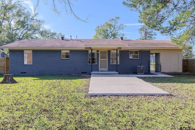 rear view of house featuring a yard, a patio, and central AC