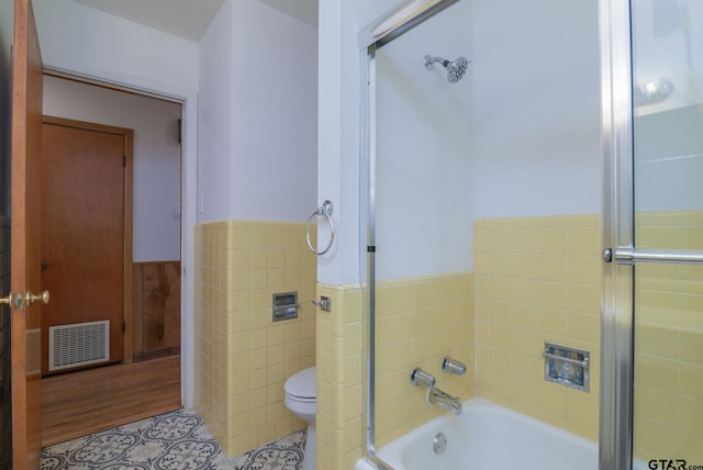 bathroom with tile patterned flooring, separate shower and tub, toilet, and tile walls