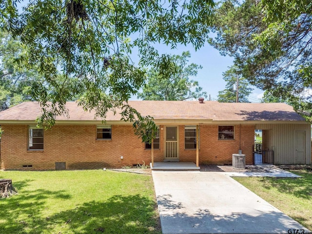 rear view of house featuring a carport and a lawn