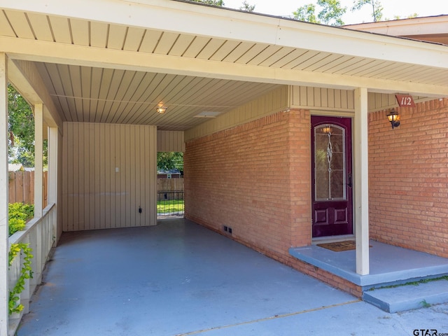 view of exterior entry with a carport