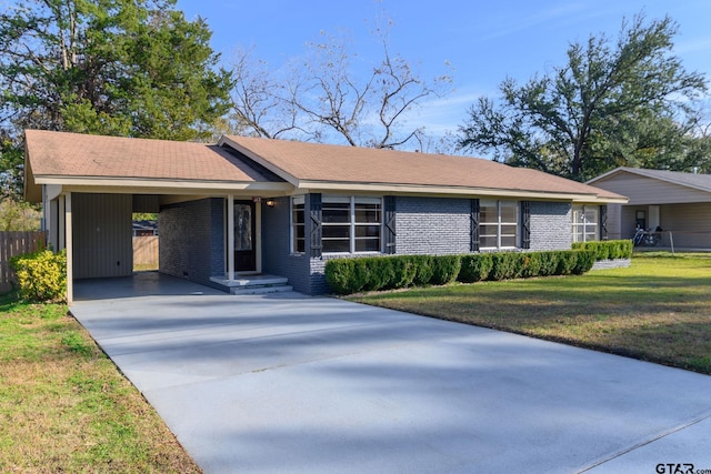 single story home featuring a carport and a front lawn