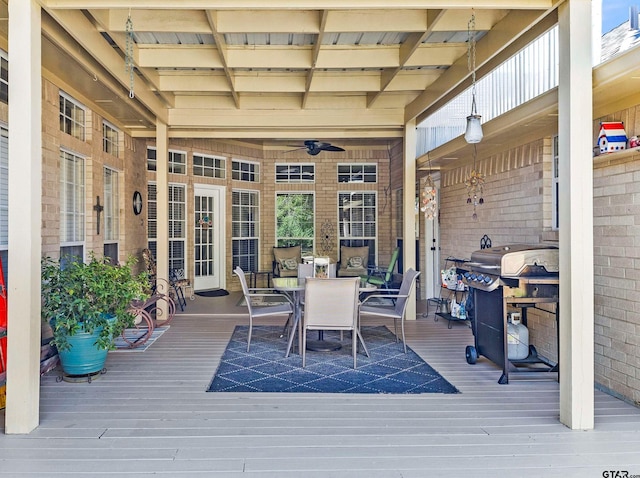 wooden terrace with area for grilling and ceiling fan