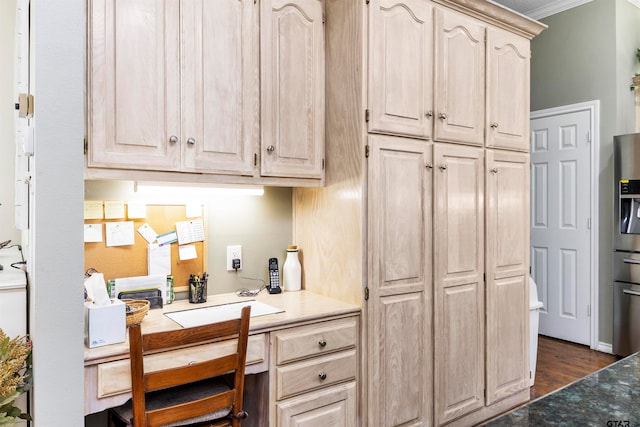 kitchen featuring built in desk, sink, light brown cabinets, crown molding, and dark wood-type flooring