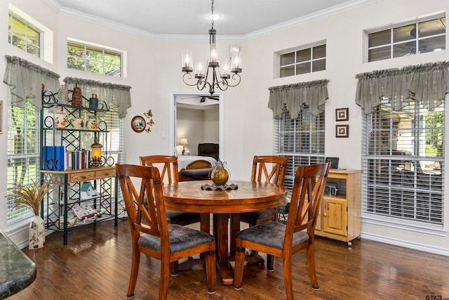 dining area featuring dark wood-type flooring, crown molding, and an inviting chandelier