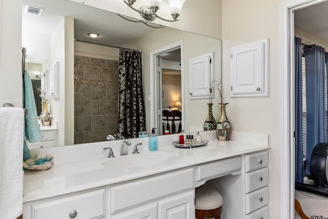 bathroom featuring vanity and curtained shower