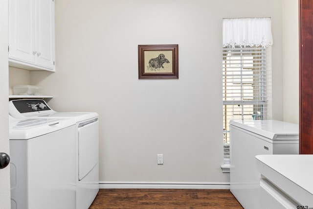 laundry area with cabinets, separate washer and dryer, and dark hardwood / wood-style floors