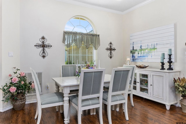 dining room with dark hardwood / wood-style flooring and crown molding