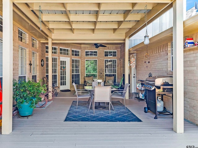 wooden terrace with ceiling fan and a grill