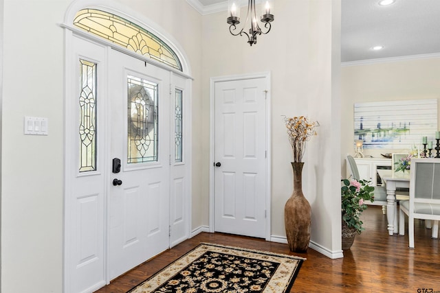 entryway featuring a chandelier, crown molding, and dark hardwood / wood-style flooring