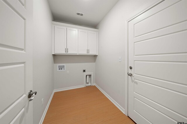 113 Hay Mdw, Winona, TX 75792 - laundry room featuring hookup for an electric dryer, hookup for a washing machine, light wood-type flooring, and baseboards