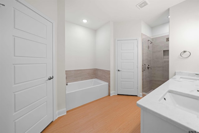 113 Hay Mdw, Winona, TX 75792 - full bathroom featuring wood finished floors, a shower stall, a garden tub, recessed lighting, and double vanity