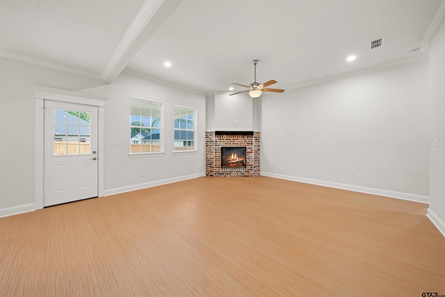 113 Hay Mdw, Winona, TX 75792 - unfurnished living room with a ceiling fan, ornamental molding, a brick fireplace, light wood-style flooring, and recessed lighting