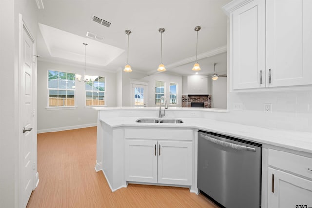 113 Hay Mdw, Winona, TX 75792 - kitchen with stainless steel dishwasher, a sink, light wood-type flooring, backsplash, and white cabinets