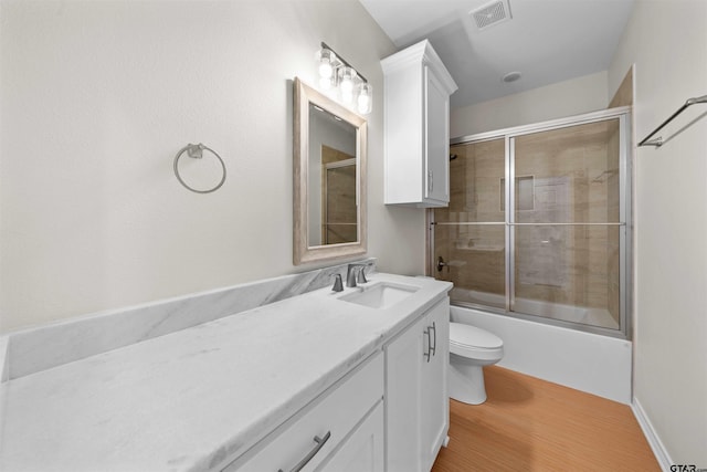 113 Hay Mdw, Winona, TX 75792 - bathroom with toilet, vanity, wood finished floors, and shower / bath combination with glass door