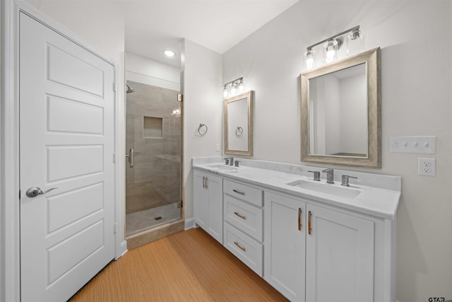 113 Hay Mdw, Winona, TX 75792 - bathroom with a stall shower, double vanity, wood finished floors, and recessed lighting