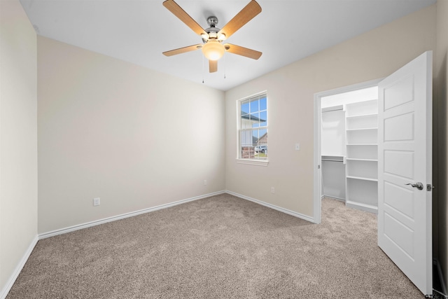 113 Hay Mdw, Winona, TX 75792 - unfurnished bedroom featuring carpet flooring, a walk in closet, baseboards, a closet, and ceiling fan