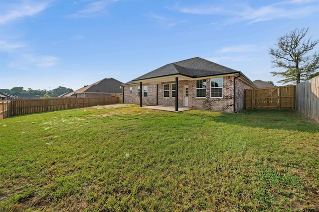 113 Hay Mdw, Winona, TX 75792 - rear view of house featuring a patio area, brick siding, a shingled roof, and a gate