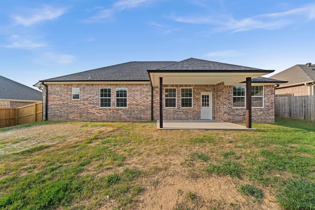 113 Hay Mdw, Winona, TX 75792 - rear view of house featuring a patio, brick siding, and roof with shingles