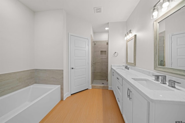 113 Hay Mdw, Winona, TX 75792 - full bath with a shower stall, a bath, double vanity, and wood finished floors