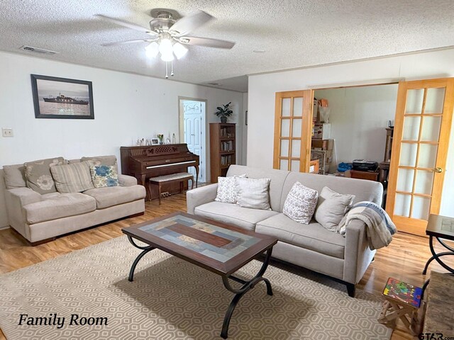 237 Oregon St, Van, TX 75790 - living area with french doors, wood finished floors, a ceiling fan, and a textured ceiling