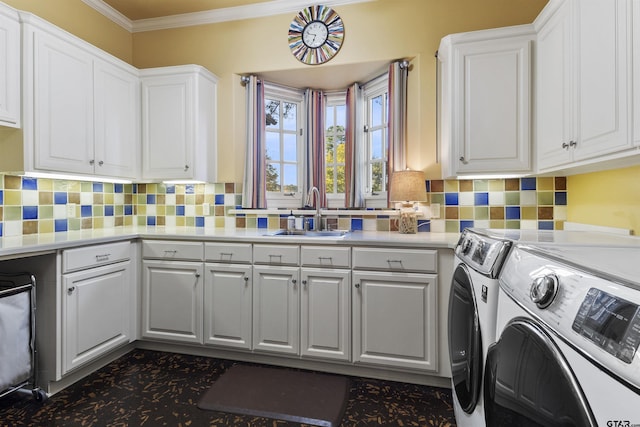 2205 Kingsmill Cir, Tyler, TX 75703 - laundry room featuring separate washer and dryer, a sink, cabinet space, and crown molding