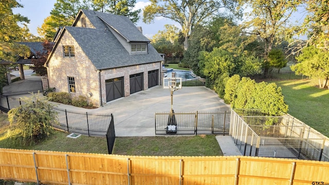 2205 Kingsmill Cir, Tyler, TX 75703 - view of side of home featuring brick siding, a yard, a shingled roof, fence private yard, and driveway