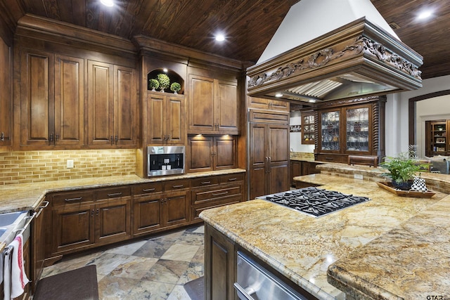 2205 Kingsmill Cir, Tyler, TX 75703 - kitchen with dark brown cabinetry, tasteful backsplash, wooden ceiling, custom exhaust hood, and stainless steel gas cooktop