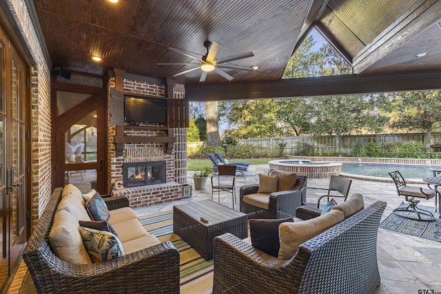 2205 Kingsmill Cir, Tyler, TX 75703 - view of patio / terrace featuring a fenced in pool, a fenced backyard, ceiling fan, and an outdoor living space with a fireplace