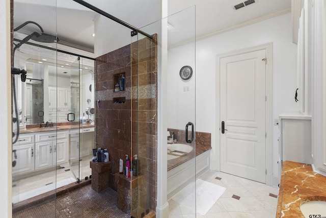2205 Kingsmill Cir, Tyler, TX 75703 - full bath with vanity, visible vents, ornamental molding, a shower stall, and a bath