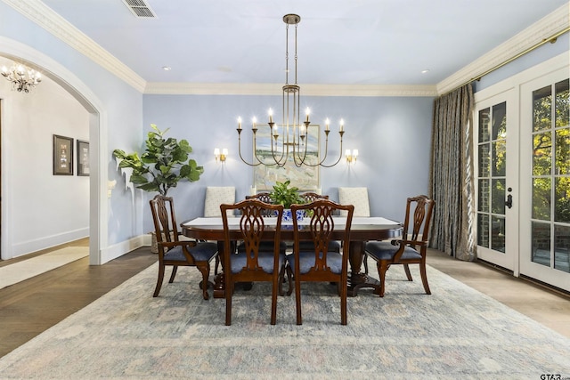 2205 Kingsmill Cir, Tyler, TX 75703 - dining space featuring arched walkways, french doors, visible vents, and an inviting chandelier