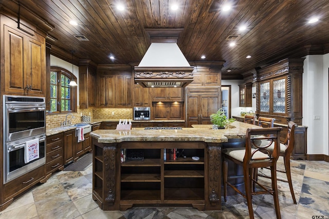 2205 Kingsmill Cir, Tyler, TX 75703 - kitchen featuring open shelves, light stone counters, appliances with stainless steel finishes, and a center island