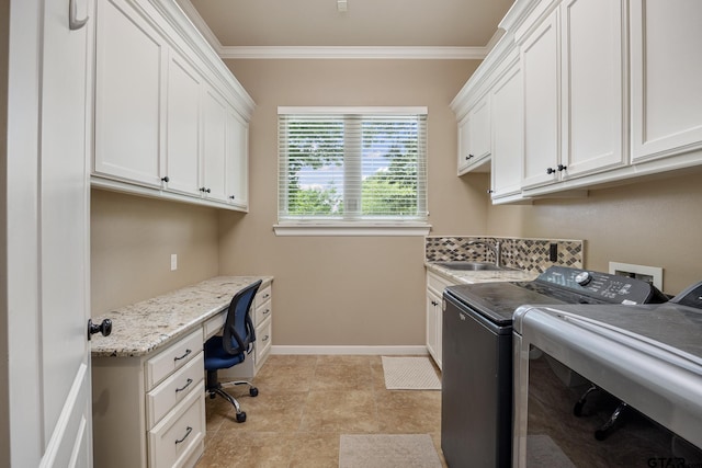 laundry area with separate washer and dryer, ornamental molding, cabinet space, an office area, and baseboards