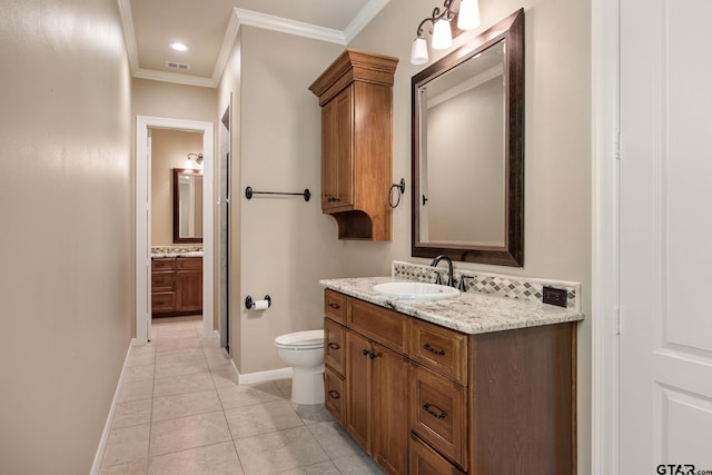 bathroom with ornamental molding, baseboards, vanity, toilet, and tile patterned flooring