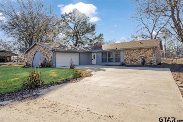 ranch-style home with a front yard and a garage