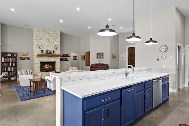 kitchen with blue cabinetry, hanging light fixtures, a center island, sink, and stainless steel dishwasher