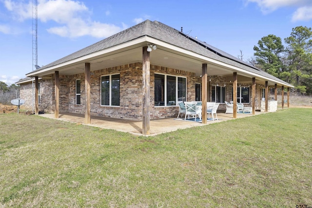 rear view of property featuring a patio area and a yard