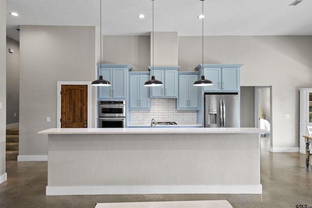 kitchen featuring blue cabinetry, stainless steel appliances, and a kitchen island with sink