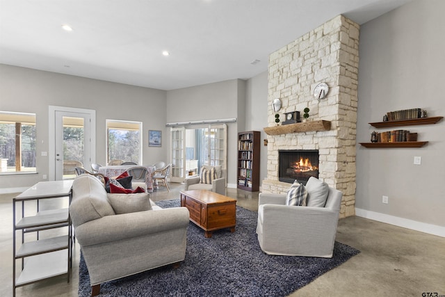 living room featuring a stone fireplace