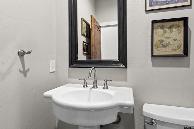 bathroom with sink and toilet